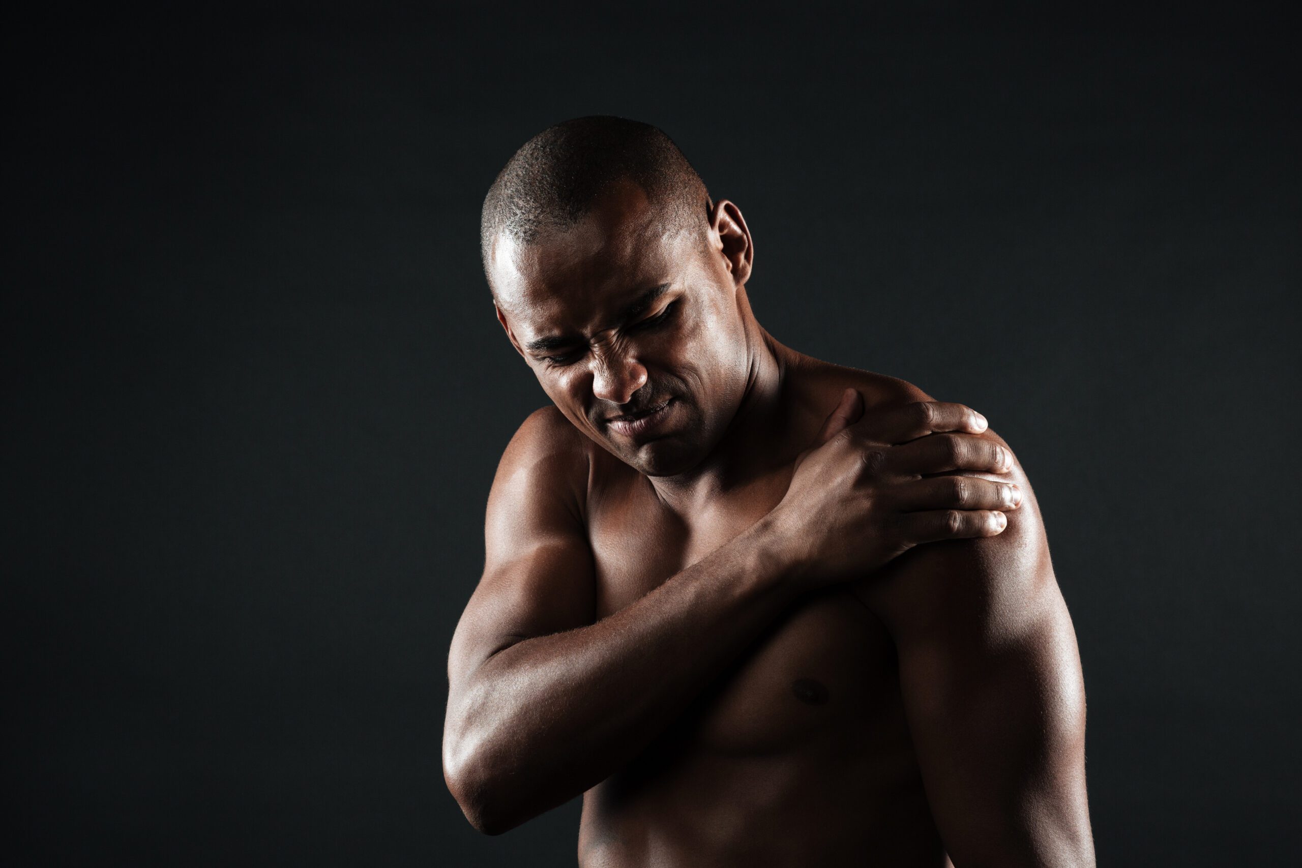 A person with shoulder pain getting assistance.